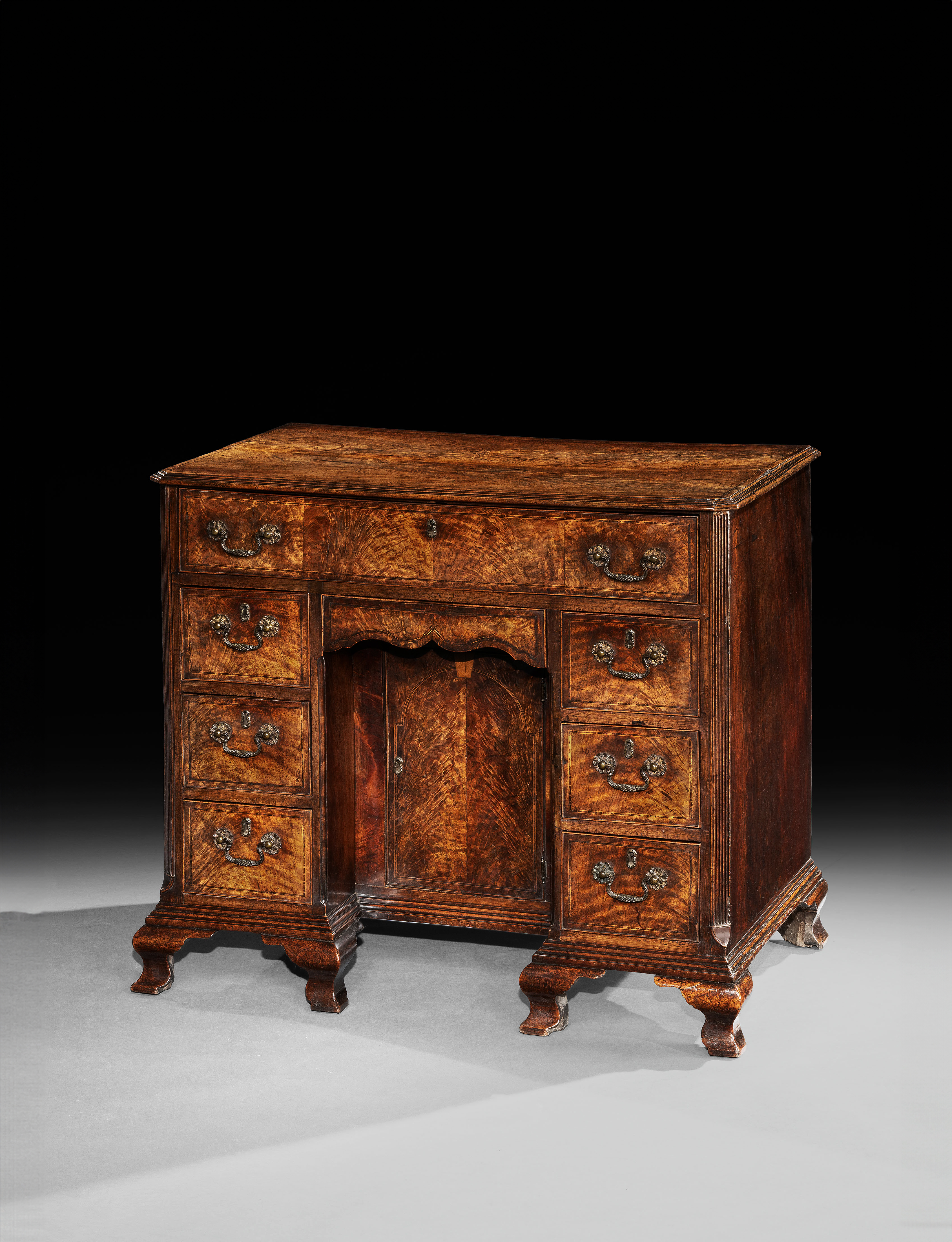 A George II Fiddleback Walnut Kneehole Desk